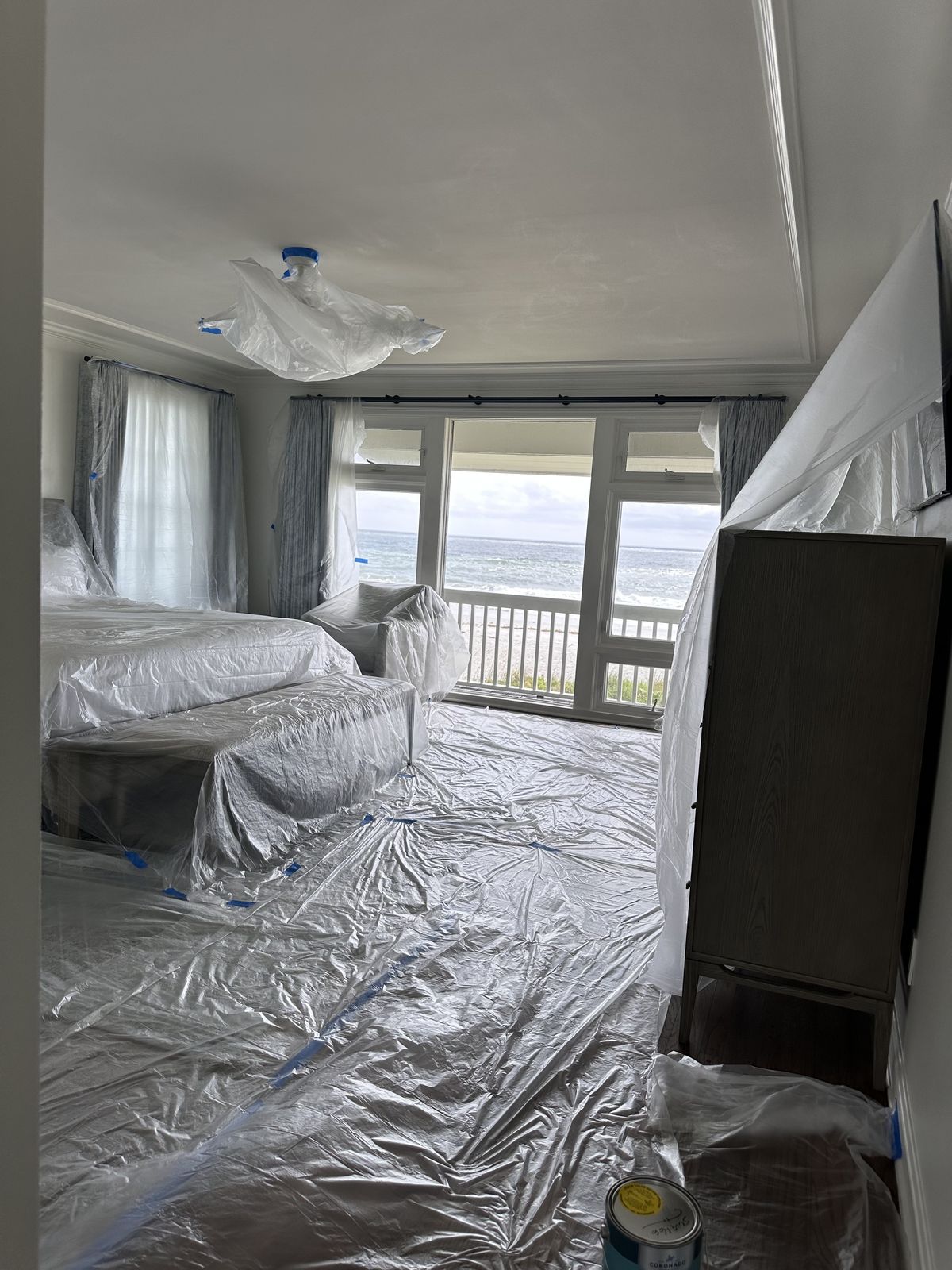Hospitality Improvements Inc. crew prepping and protecting an oceanfront bedroom before interior painting in Jacksonville FL